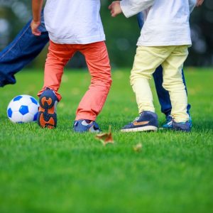 father-and-sons-playing-football-in-park-2026-01-07-00-11-44-utc
