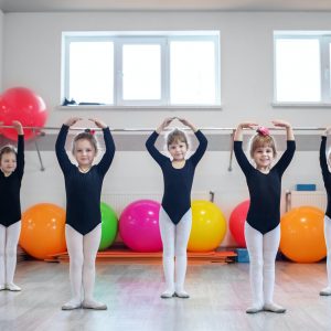 Little kids dance in dance class. The concept of sport, education, childhood, hobbies and dance.